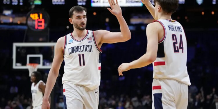 Alex Karaban and Braylon Mullins high-five during a UConn game.