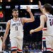 Alex Karaban and Braylon Mullins high-five during a UConn game.