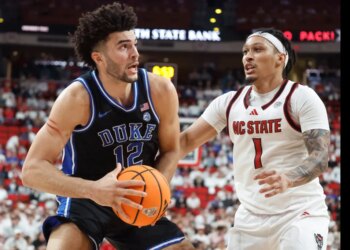 Cameron Boozer (Duke) driving the ball past Darrion Williams (NC State).