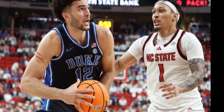Cameron Boozer (Duke) driving the ball past Darrion Williams (NC State).