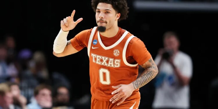 Jordan Pope in a Texas uniform reacts during a basketball game.