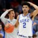 Duke guard Cayden Boozer (2) and head coach Jon Scheyer call a play during a basketball game.