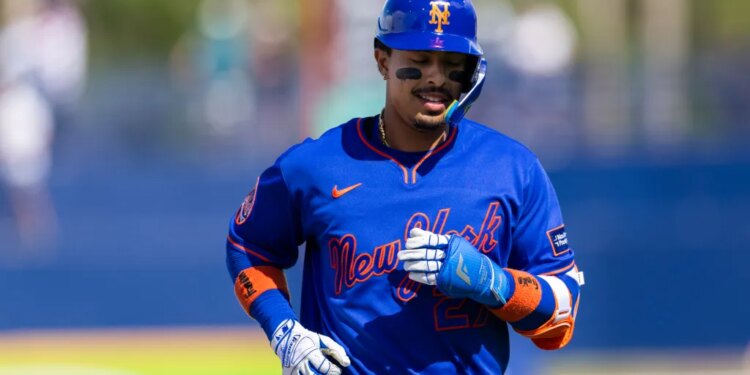New York Mets infielder Mark Vientos (27) in a blue uniform and helmet with orange "NY" logo and black eye black.