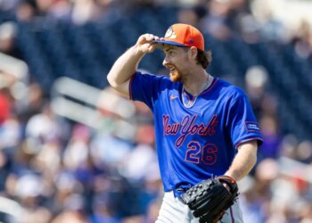 New York Mets pitcher Nolan McLean adjusts his hat after the fourth inning.