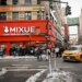 A Mixue coffee shop on Broadway in Koreatown, New York, with a long line of customers outside.