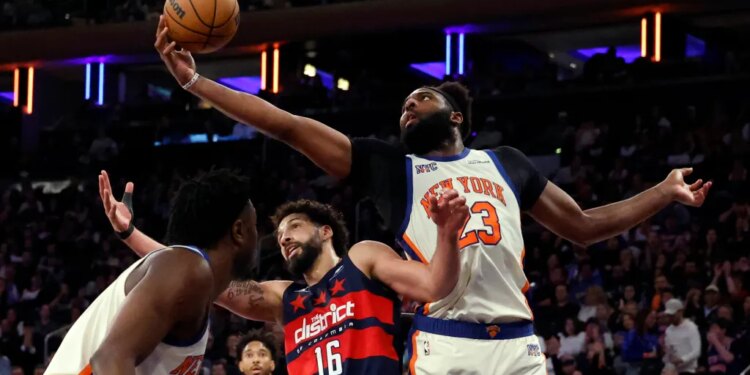 03/22/26 New York Knicks vs Washington Wizards at Madison Square Garden: Center Mitchell Robinson #23 of the New York Knicks pulls a rebound away from forward Anthony Gill #16 of the Washington Wizards