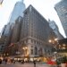 The Roosevelt Hotel in NYC, seen from the street, with pedestrians and cars in the foreground.