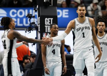 San Antonio Spurs guard Devin Vassell, left, celebrates with forward Victor Wembanyama (1) after scoring against the Detroit Pistons during the second half of an NBA basketball game Monday, Feb. 23, 2026, in Detroit.