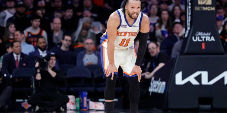 New York Knicks guard Jalen Brunson reacts after a Washington Wizards player landed on his leg.