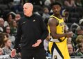 Indiana Pacers coach Rick Carlisle reacts with player Kobe Brown during a basketball game against the Milwaukee Bucks.