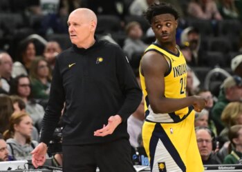 Indiana Pacers coach Rick Carlisle reacts with player Kobe Brown during a basketball game against the Milwaukee Bucks.