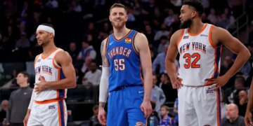 Oklahoma City Thunder center Isaiah Hartenstein #55 is all smiles between New York Knicks guard Josh Hart #3 and New York Knicks center Karl-Anthony Towns #32 during the third quarter at Madison Square Garden.