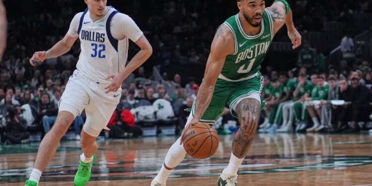Boston Celtics forward Jayson Tatum (0) drives to the basket.