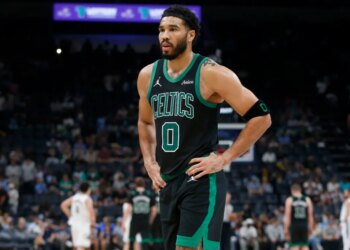 Boston Celtics forward Jayson Tatum (0) walks toward the bench.