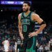Boston Celtics forward Jayson Tatum (0) walks toward the bench.