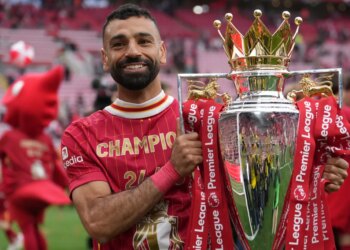 Liverpool's Mohamed Salah poses with the winner's trophy after the English Premier League soccer match between Liverpool and Crystal Palace at the Anfield stadium in Liverpool, England, May 25, 2025.