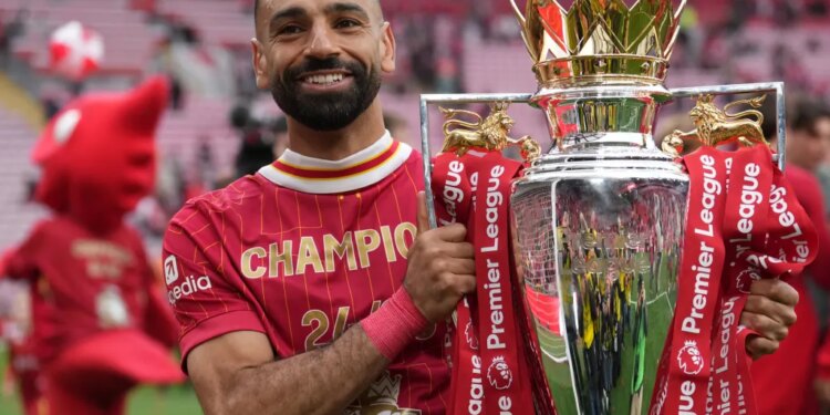 Liverpool's Mohamed Salah poses with the winner's trophy after the English Premier League soccer match between Liverpool and Crystal Palace at the Anfield stadium in Liverpool, England, May 25, 2025.
