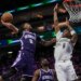 Malik Monk attempts a dunk for the Sacramento Kings while E.J. Liddell of the Brooklyn Nets defends.