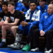 Injured Duke Blue Devils guard Caleb Foster wearing a walking boot on the bench.  Injured Duke Blue Devils guard Caleb Foster (center) looks on with a while wearing a walking boot during the second half against the North Carolina Tar Heels at Cameron Indoor Stadium.