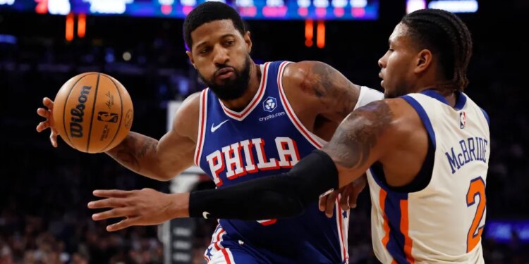 Philadelphia 76ers forward Paul George drives two the basket as New York Knicks guard Miles McBride defends in the first half at Madison Square Garden in Manhattan, New York, Saturday, January 03, 2026.