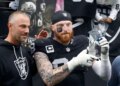 Las Vegas Raiders defensive end Maxx Crosby (98) lifts his award as general manager John Spytek, left, looks on after receiving the Walter Payton Man of the Year Award before a game against the Denver Broncos at Allegiant Stadium on Dec. 7, 2025, in Las Vegas.