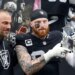 Las Vegas Raiders defensive end Maxx Crosby (98) lifts his award as general manager John Spytek, left, looks on after receiving the Walter Payton Man of the Year Award before a game against the Denver Broncos at Allegiant Stadium on Dec. 7, 2025, in Las Vegas.