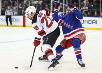 Noah Laba (right), who exited with a lower-body injury, defends against Timo Meier during the second period of the Rangers-Devils game on March 18 2026 at the Garden.