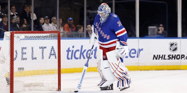 New York Rangers goalie Igor Shesterkin (31) stands on the ice next to the goal.