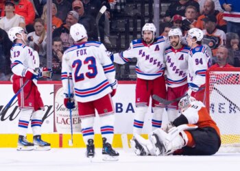 Mika Zibanejad, Adam Fox, Gabe Perreault, and Alexis Lafreniere of the New York Rangers celebrate a goal against Dan Vladar of the Philadelphia Flyers.