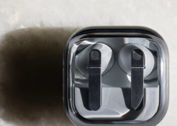 The Samsung Galaxy Buds 4 Pro in their charging case on a white tabletop.