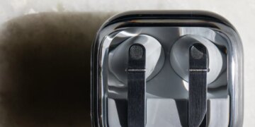 The Samsung Galaxy Buds 4 Pro in their charging case on a white tabletop.