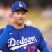Shohei Ohtani in a Dodgers uniform with a baseball on his shoulder.