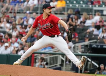 Baseball player Spencer Strider pitches a baseball.