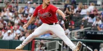 Baseball player Spencer Strider pitches a baseball.