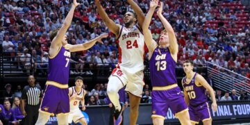 Forward Zuby Ejiofor #24 of the St. John's Red Storm goes up for a shot between forward Ben Schwieger #7 of the Northern Iowa Panthers and forward Will Hornseth #13 of the Northern Iowa Panthers during the first half.
