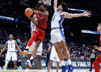 St. John's Red Storm forward Zuby Ejiofor looks to pass past the Duke Blue Devils defense in the first half during the NCAA East Regionals, Sweet Sixteen tournament at Capital One Arena in Washington, DC on March 27, 2026.