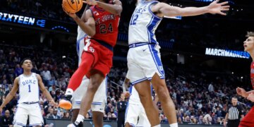 St. John's Red Storm forward Zuby Ejiofor looks to pass past the Duke Blue Devils defense in the first half during the NCAA East Regionals, Sweet Sixteen tournament at Capital One Arena in Washington, DC on March 27, 2026.