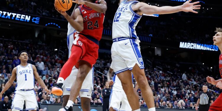 St. John's Red Storm forward Zuby Ejiofor looks to pass past the Duke Blue Devils defense in the first half during the NCAA East Regionals, Sweet Sixteen tournament at Capital One Arena in Washington, DC on March 27, 2026.