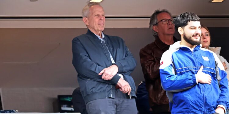 New York Giants co-owner Steve Tisch standing during the singing of the National Anthem at the start of the game.