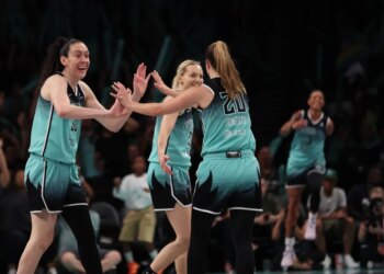 New York Liberty players Breanna Stewart and Sabrina Ionescu high-five during a game against the Phoenix Mercury.