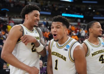 Yaxel Lendeborg, Trey McKenney, and Nimari Burnett celebrate their Sweet 16 victory in the NCAA tournament.
