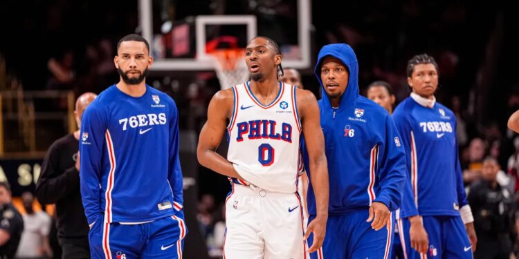 Philadelphia 76ers guard Tyrese Maxey (0) reacts and is assisted after being injured against the Atlanta Hawks during the second half at State Farm Arena.