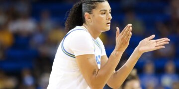 Lauren Betts clapping during a basketball game.