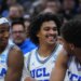 UCLA basketball player Skyy Clark smiles while missing a front tooth and with blood on his gum.