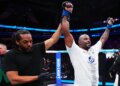 Tyrell Fortune celebrates his victory against Marcin Tybura with his hand raised by the referee at UFC Fight Night.