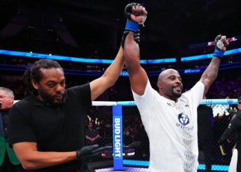 Tyrell Fortune celebrates his victory against Marcin Tybura with his hand raised by the referee at UFC Fight Night.