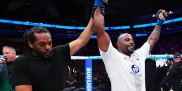 Tyrell Fortune celebrates his victory against Marcin Tybura with his hand raised by the referee at UFC Fight Night.