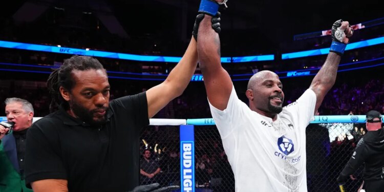 Tyrell Fortune celebrates his victory against Marcin Tybura with his hand raised by the referee at UFC Fight Night.