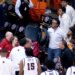 An angry UTEP fan picks up a chair and gestures toward Jacksonville State players after a men's college basketball game on March 7, 2026.
