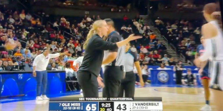 A coach argues with a referee on a basketball court during an SEC Tournament game between Ole Miss and Vanderbilt.